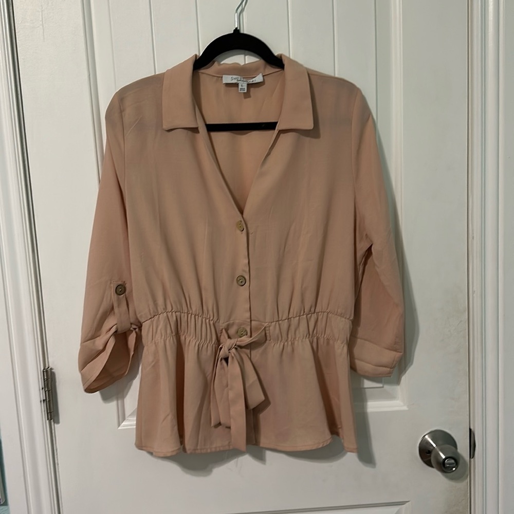 This is a blazer. It is tan colored, with a thin material.